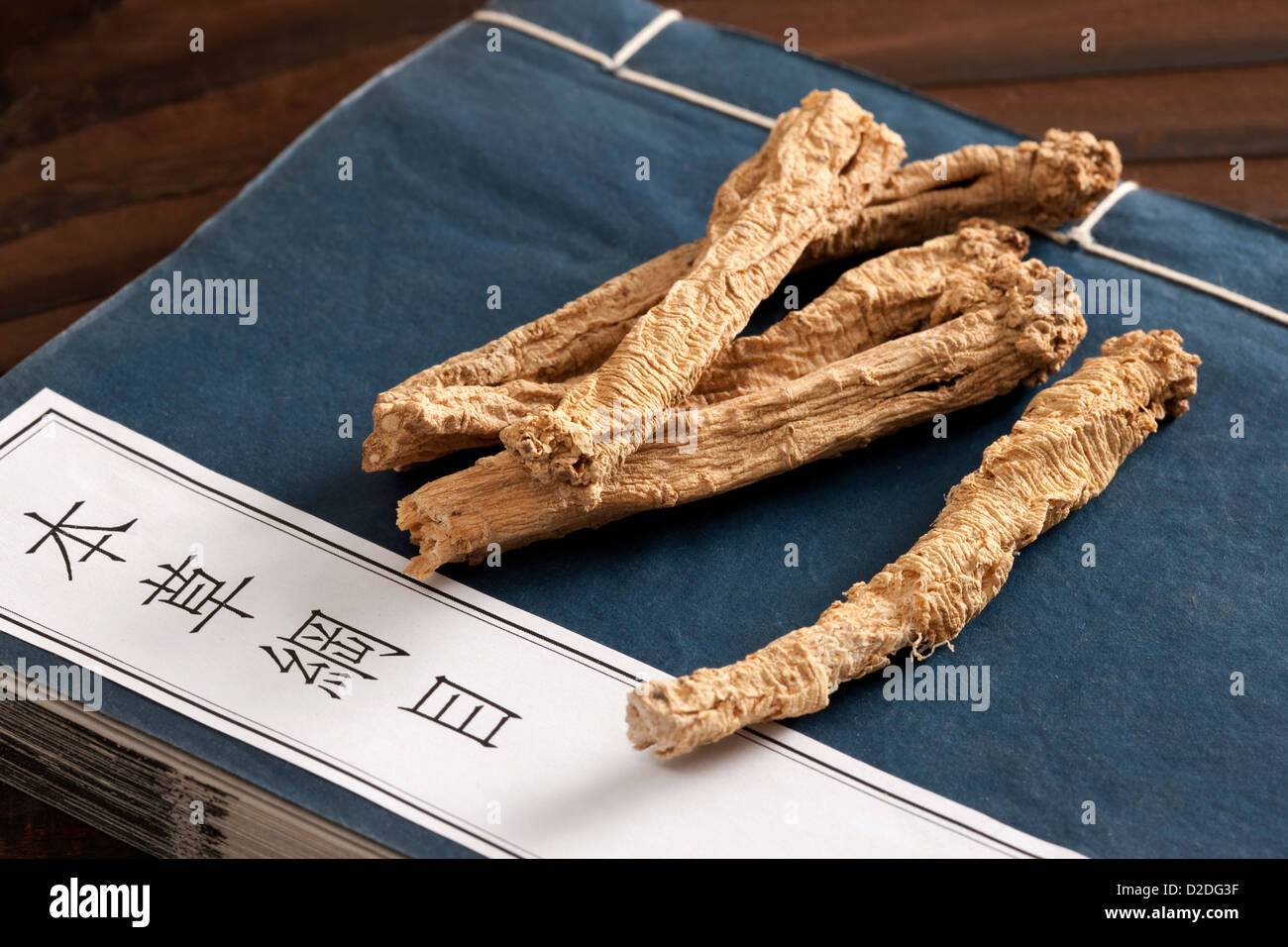 Chinese herbal medicine codonopsis pilosula with the ancient Chinese medical book Stock Photo