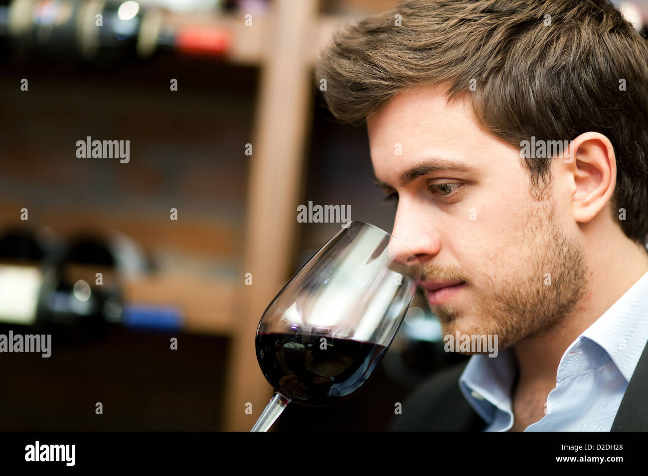 Portrait of a sommelier looking to a wine glass Stock Photo