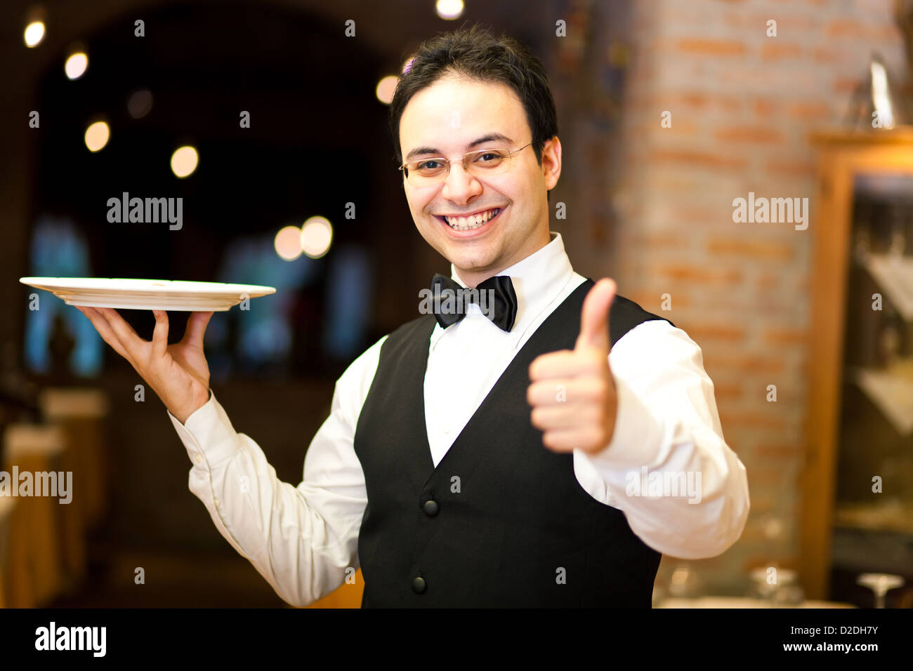 Waiter holding a plate Stock Photo Alamy