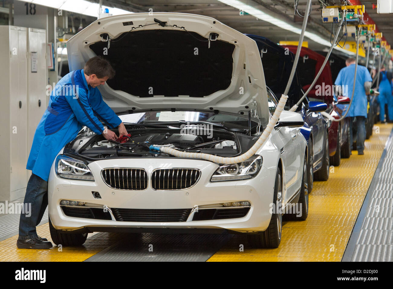 A BMW employee works on a BMW 6 inside the company's plant in