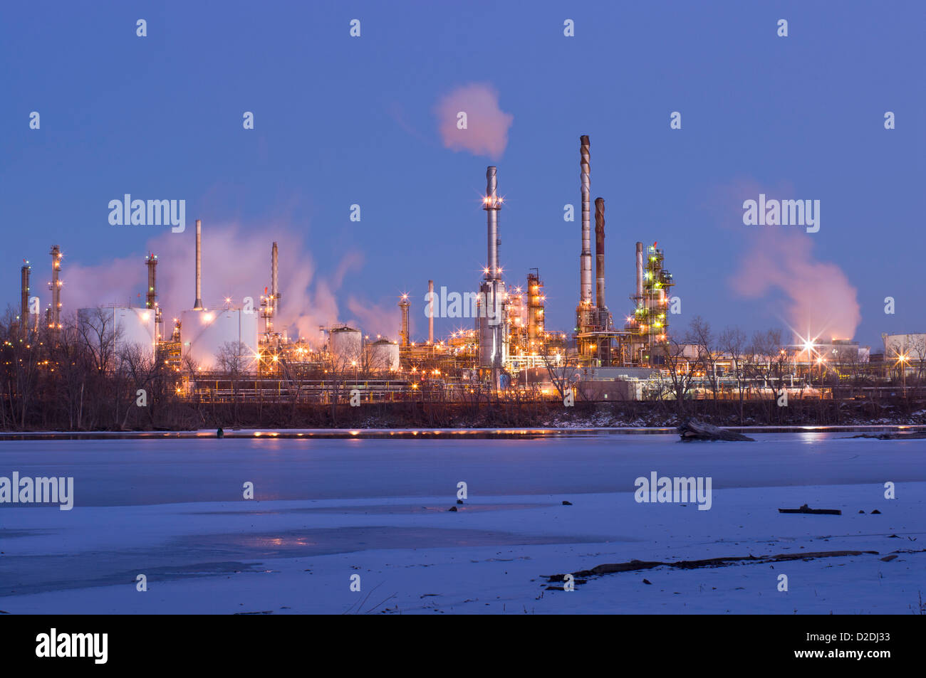 oil and petroleum refinery along frozen mississippi river in saint paul park minnesota at night Stock Photo