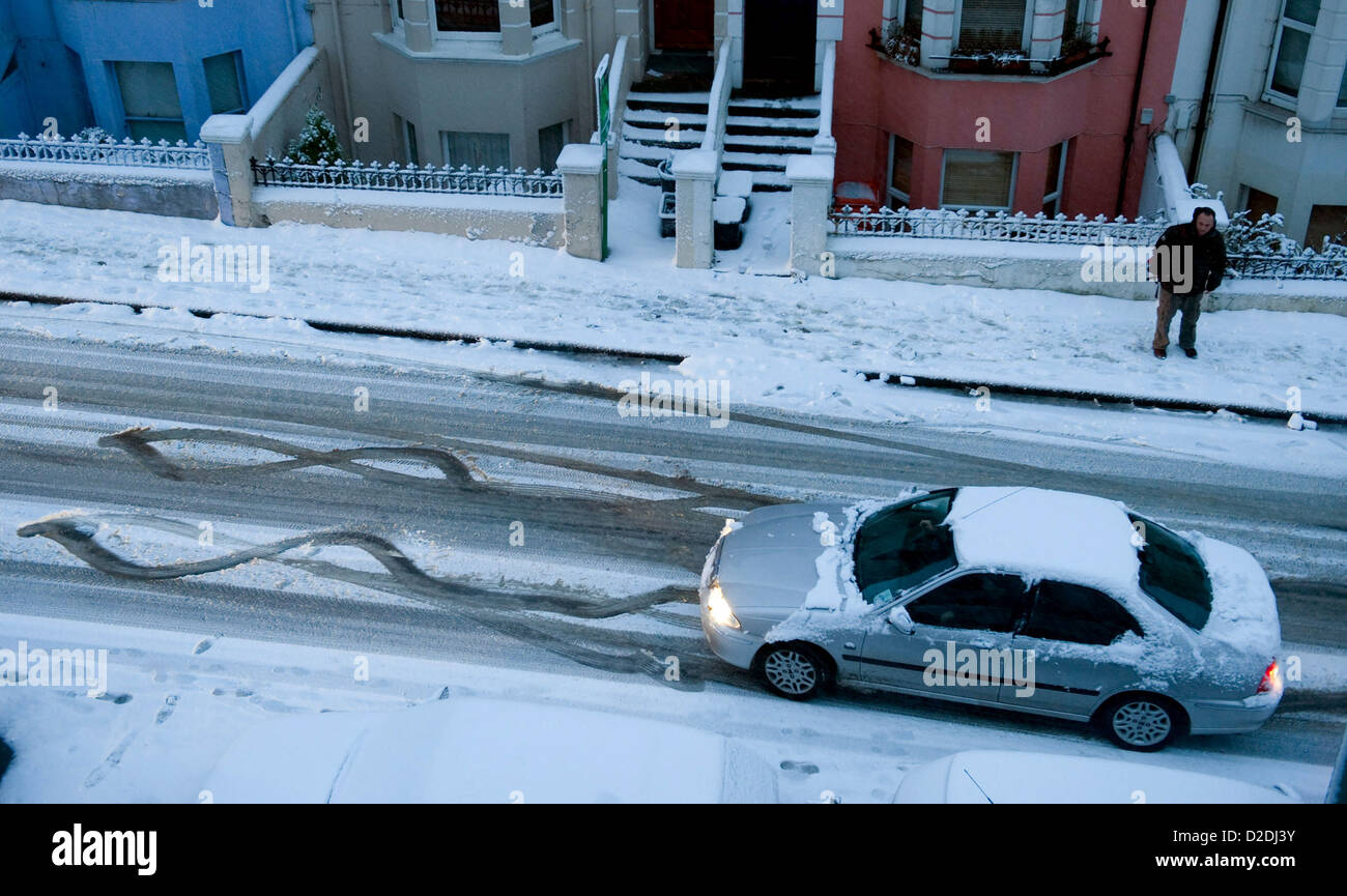 A car slides down a snow covered road in Brighton, East Sussex, England