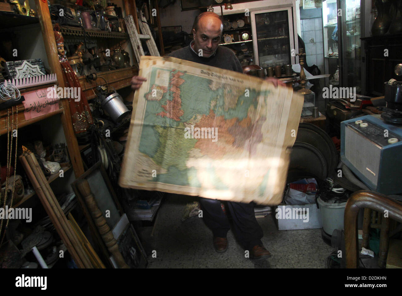 Jan. 20, 2013 - Gaza City, Gaza Strip, Palestinian Territory - A Palestinian vendor displays an old page from the Daily Telegraph newspaper shows the map of World War II prepared by the London Geographical Institute, in his antiques store in Gaza city on January 20, 2013  (Credit Image: © Ezz Al-Zanoon/APA Images/ZUMAPRESS.com) Stock Photo