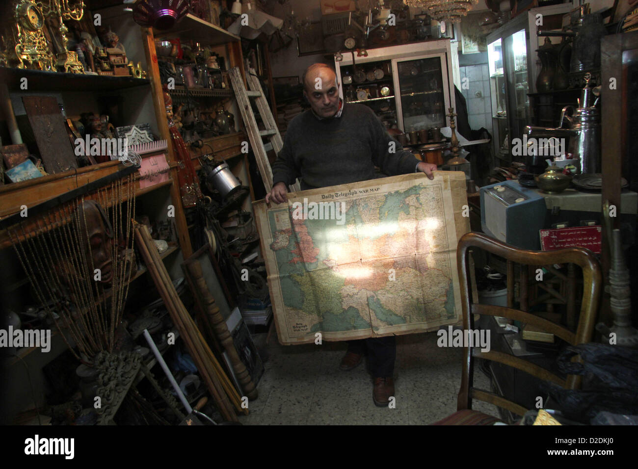 Jan. 20, 2013 - Gaza City, Gaza Strip, Palestinian Territory - A Palestinian vendor displays an old page from the Daily Telegraph newspaper shows the map of World War II prepared by the London Geographical Institute, in his antiques store in Gaza city on January 20, 2013  (Credit Image: © Ezz Al-Zanoon/APA Images/ZUMAPRESS.com) Stock Photo