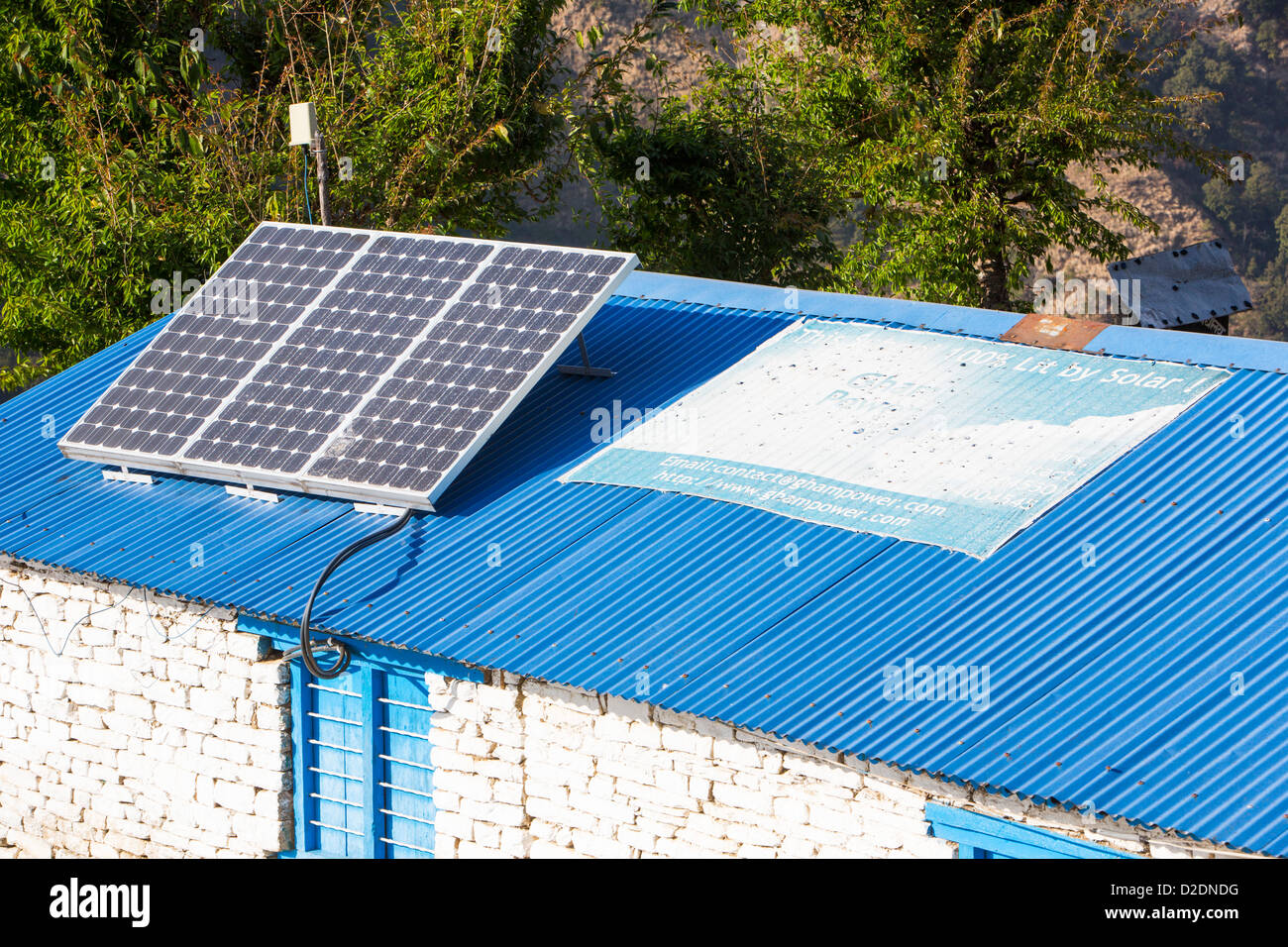Solar photo voltaic panels on the rooftops of a school in Ladruk in the Himalayan foothills, Nepal. Stock Photo