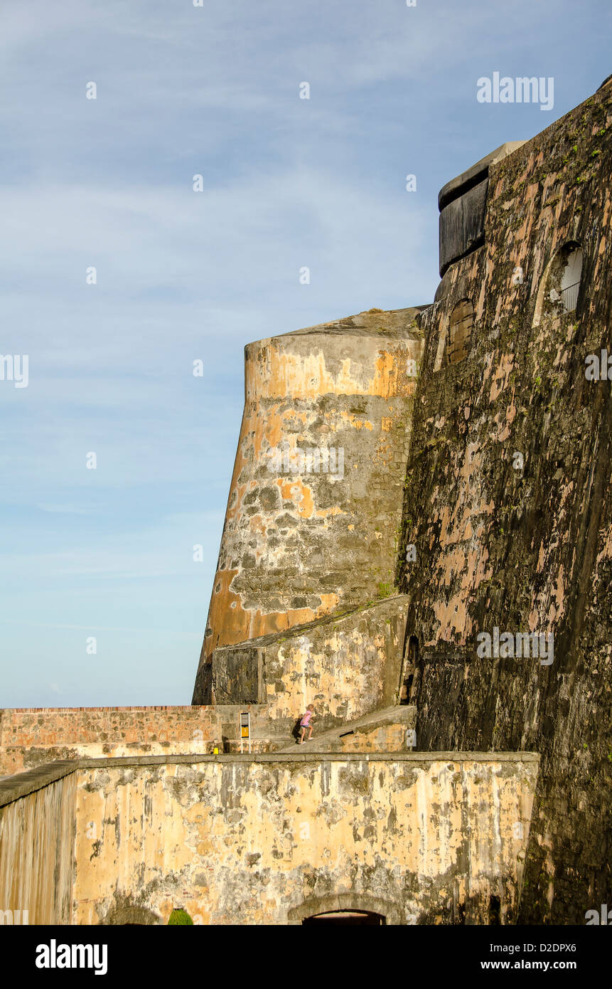 Castillo San Felipe del Morro fortress young girl dwarfed by size of the huge fort, Old San Juan, Puerto Rico Stock Photo