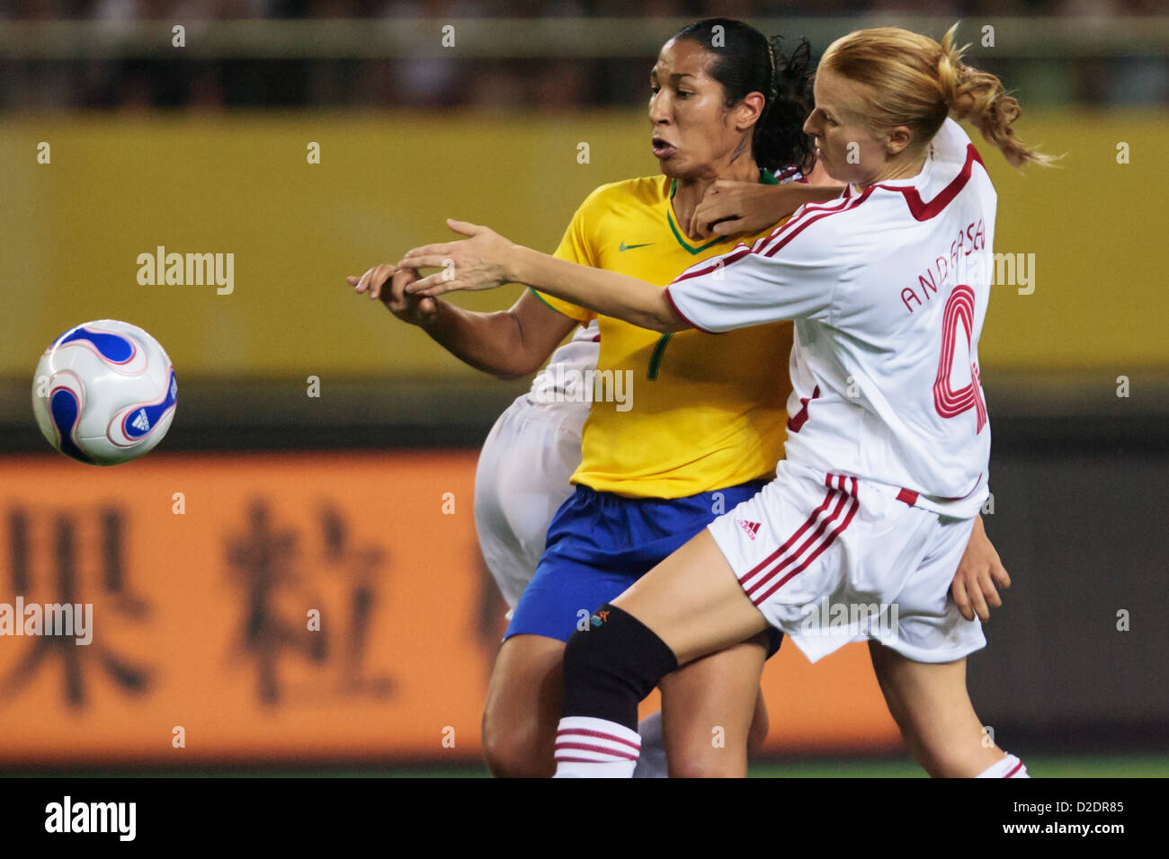 Daniela of Brazil (L) battles against Gitte Andersen of Denmark (R) during a FIFA Women's World Cup Group D match. Stock Photo