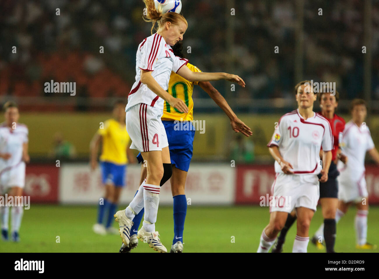 Gitte Andersen of Denmark (L) wins a header against Marta of Brazil (R) during a 2007 FIFA Women's World Cup Group D match. Stock Photo