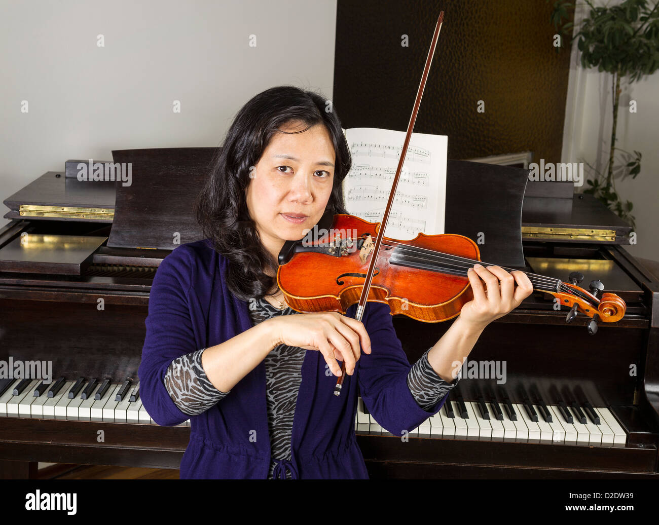 Asian chinese woman playing violin hi res stock photography and