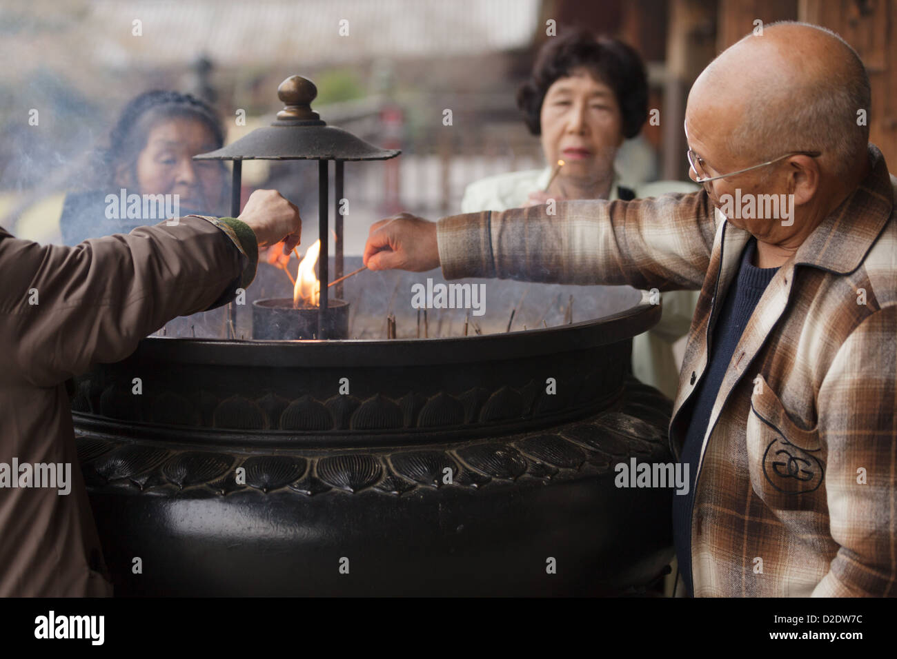 Japanese people burning incense sticks and praying at the Todaiji