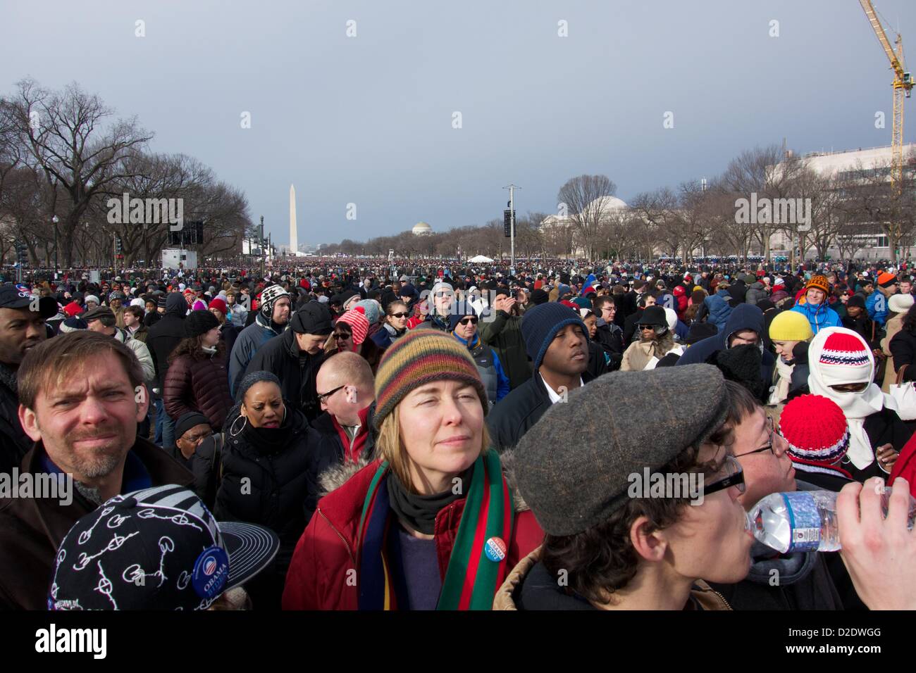 Washington DC. January 21, 2013,  A large crowd gathers on the National Mall for the inaugural ceremony. President Barack Obama, officially sworn in to a second term yesterday due to a constitutional requirement, takes a ceremonial oath of office today. Stock Photo