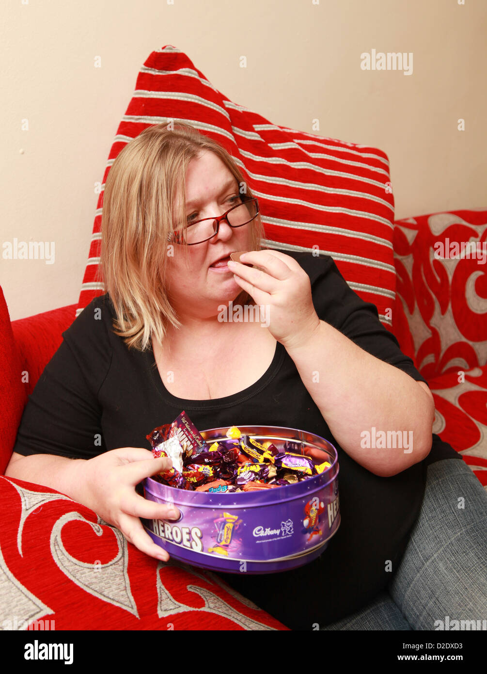 Overweight Woman Eating Chocolates Stock Photo