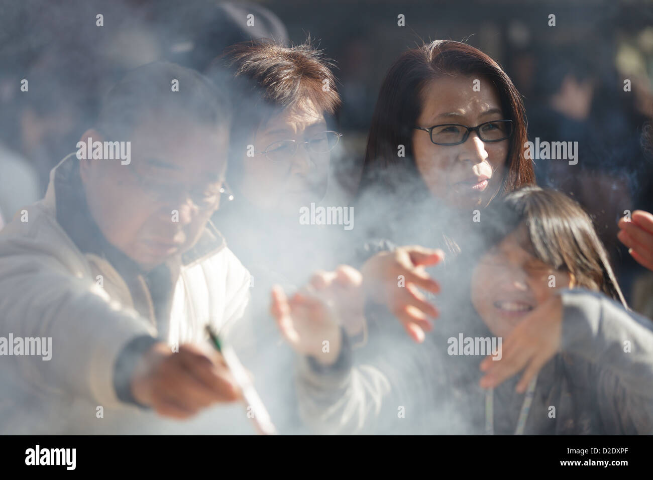 Japanese people praying at the Senso-ji  temple, Asakusa,Tokyo, Japan Stock Photo