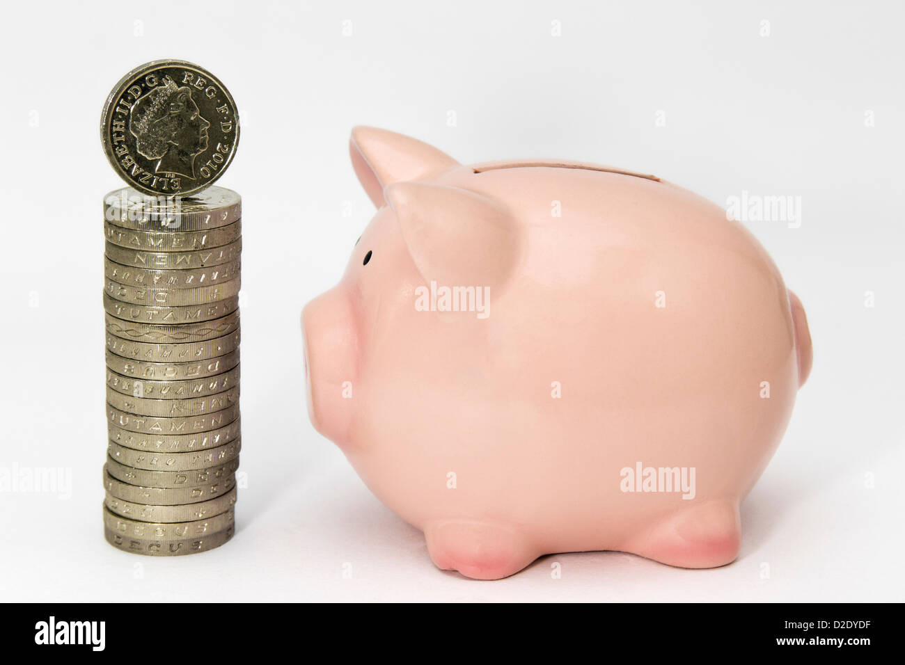 Stack of one pound coins and piggy pank Stock Photo - Alamy