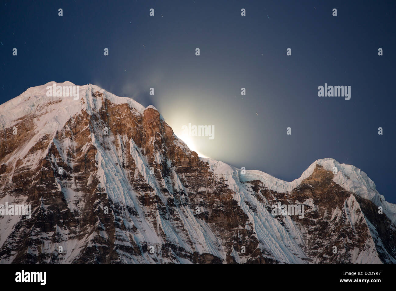 The night sky over Annapurna South and Annapurna Fang in the Annapurna Sanctuary, Himalayas, Nepal, Stock Photo