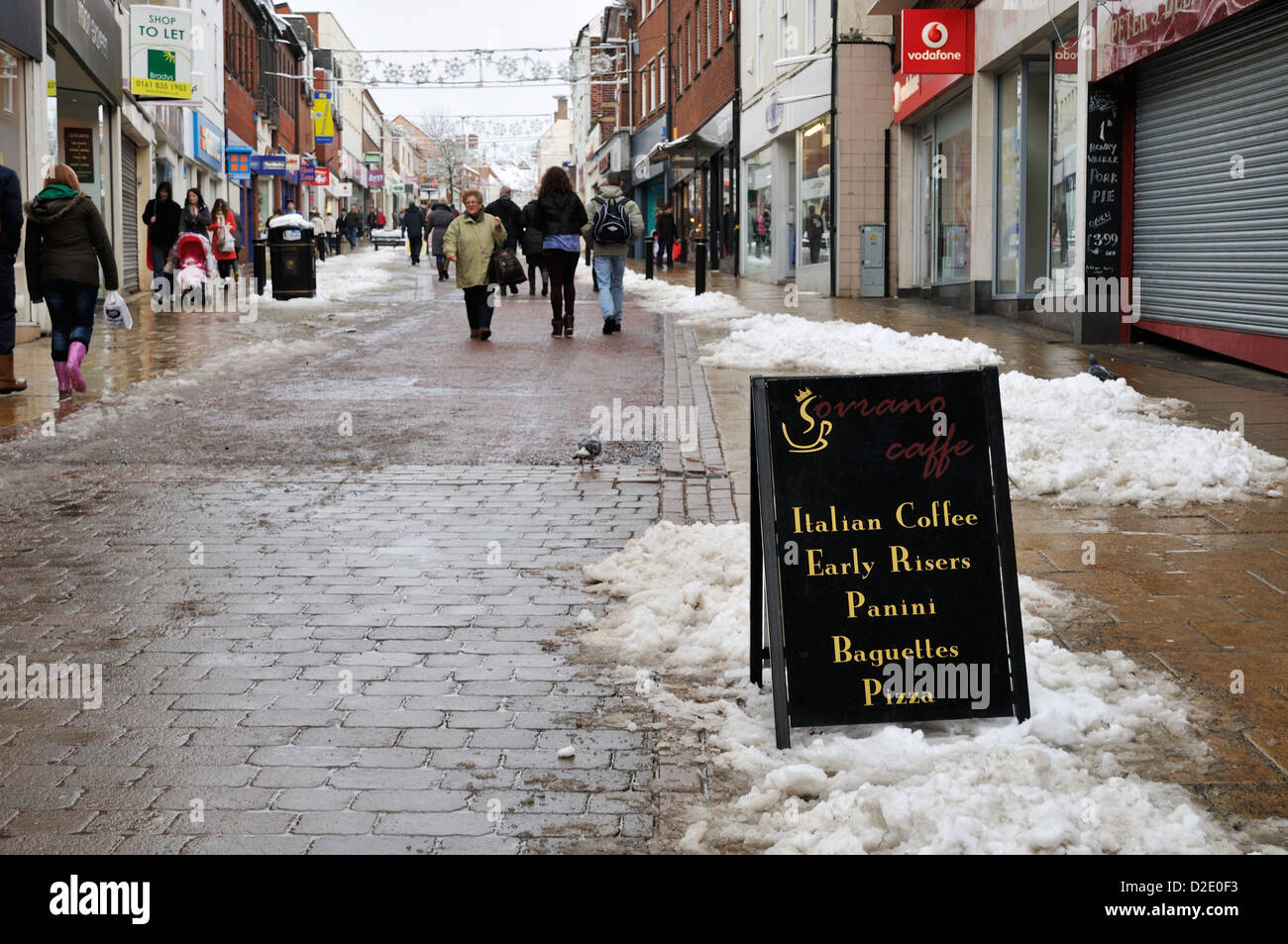 Shoppers Walking Along Castle Street In Hinckley On A Snowy Winters Day shoppers-walking-along-castle-street-in-hinckley-on-a-snowy-winters-day