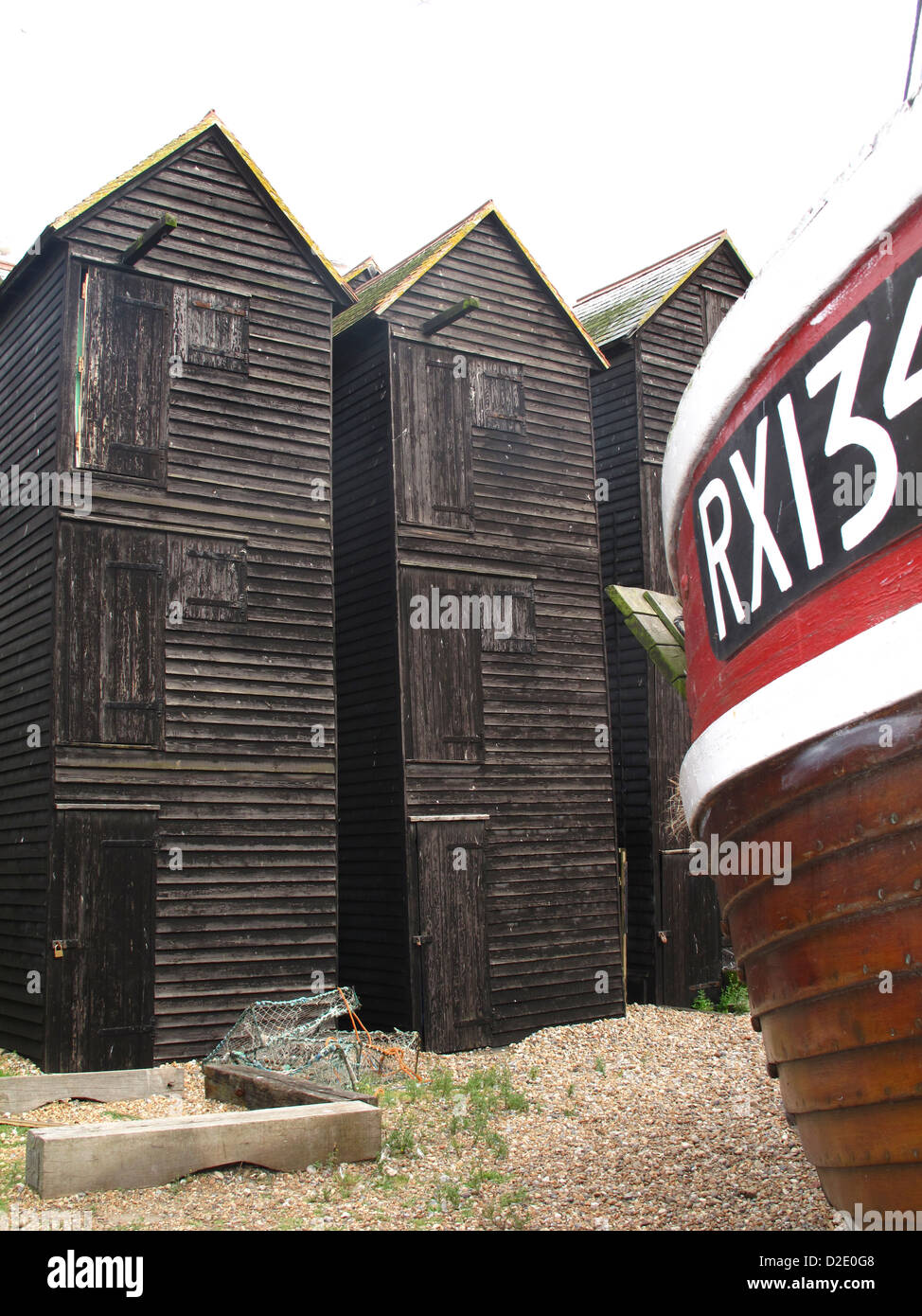 Hastings net shops or huts and fishing boat Stock Photo Alamy