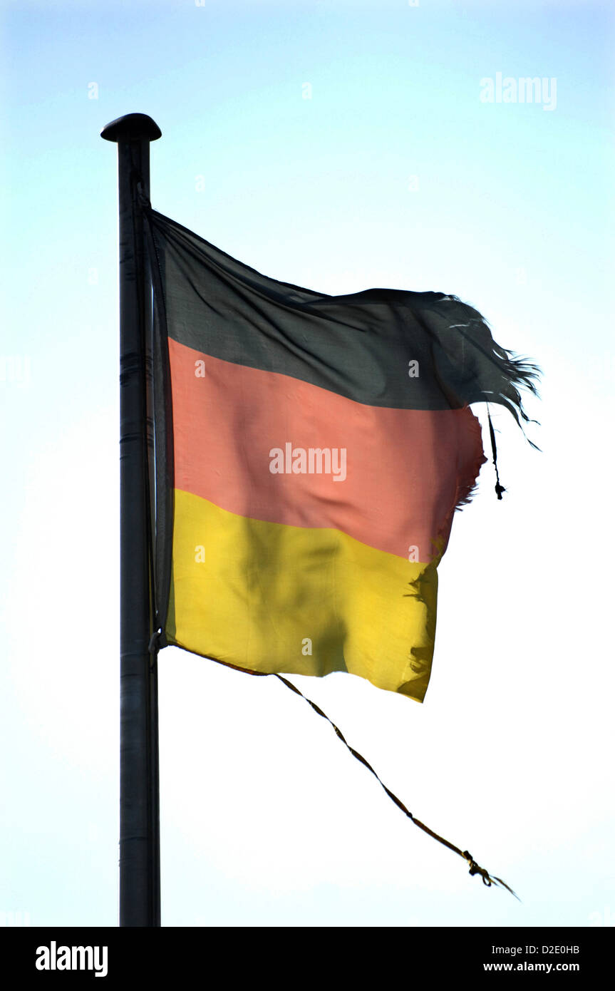 Berlin, Germany, the wind tore Germany flag on the mast Stock Photo