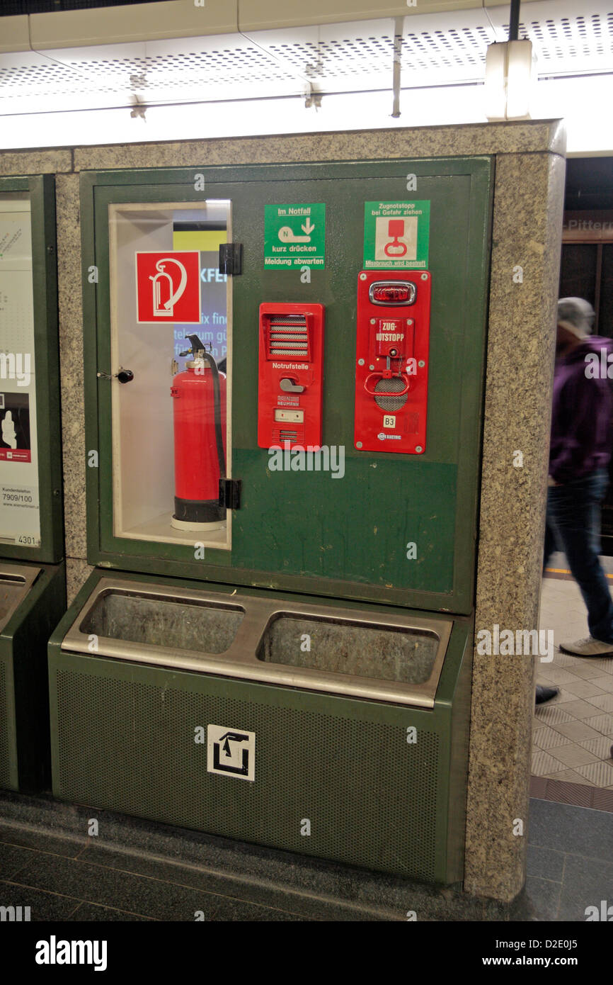 An emergency point (fire extinguisher & emergency train stop) on a train platform at a U-Bahn train station in Vienna, Austria. Stock Photo