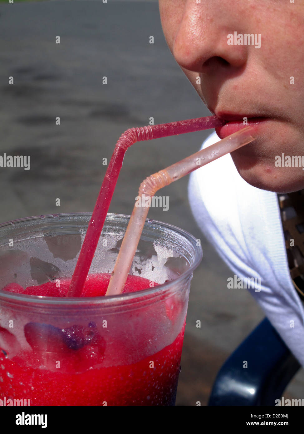 Boy drinking milk through silly straw glasses, while looking up Stock Photo