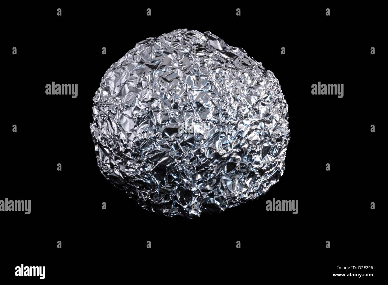 Aluminium Kitchen Foil Screwed Up Into a Ball isolated on black background Stock Photo
