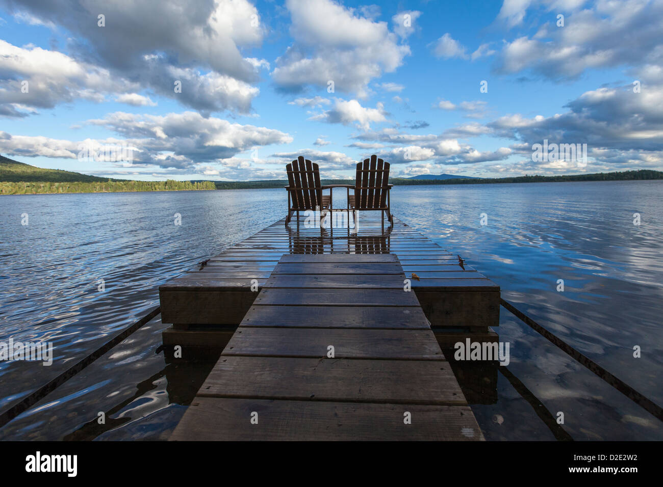 Two adirondack chair on a dock at Spencer Pond in northern Maine Stock