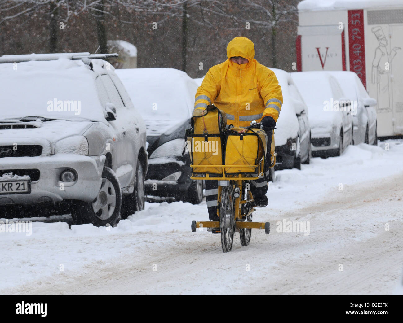 Berlin, Germany, a POSTMAN on his bicycle in snowy Berlin Stock Photo