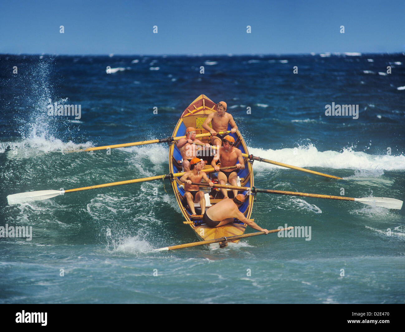 Sydney, lifesavers surfboat passing a breaker during a competition at the North Narrabeen Beach surf carnival Stock Photo