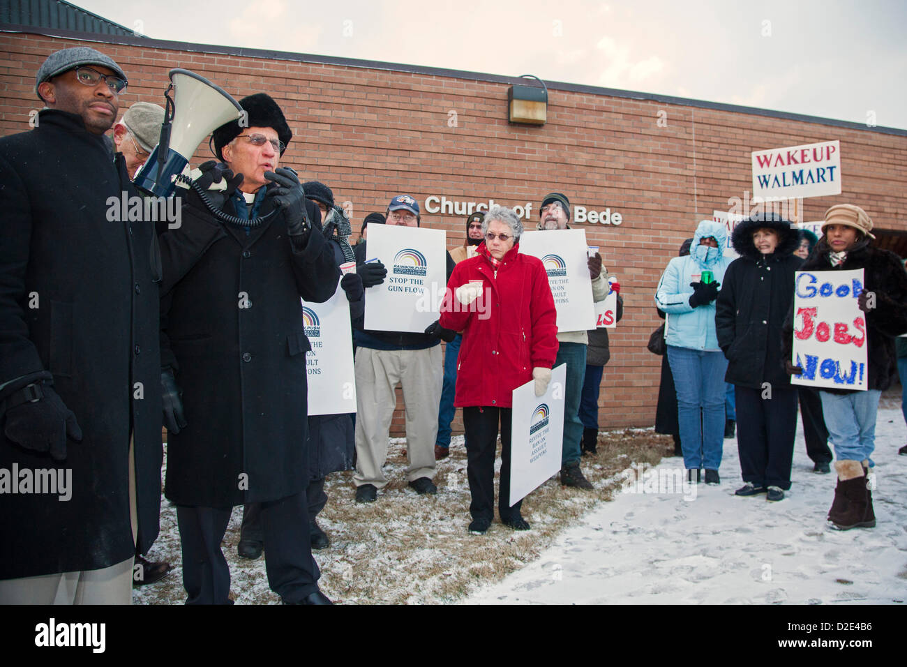 Southfield, Michigan - January 21, 2013 - Fr. Norm Thomas speaks to a 'Guns Out & Jobs In' vigil at the Church of St. Bede, opposing a plan to tear down the church to build a Walmart store. Organizers noted that Walmart is the biggest gun distributor in America, and that the retailer's jobs pay less than a living wage. The church has been vacant since the Archdiocese of Detroit merged four Catholic churches in 2007. Stock Photo