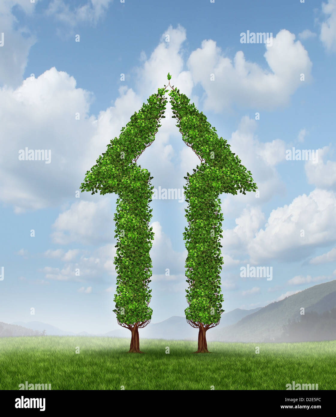 Growing group for partnership success as two trees in the shape of half an arrow coming together to form a whole upward symbol for financial wealth and high profits on a blue sky. Stock Photo