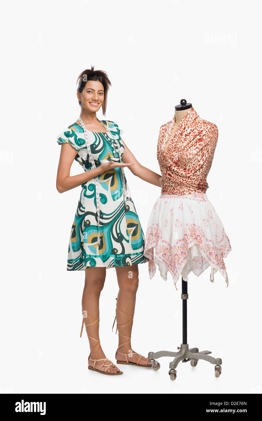 Female fashion designer showing a dress Stock Photo - Alamy