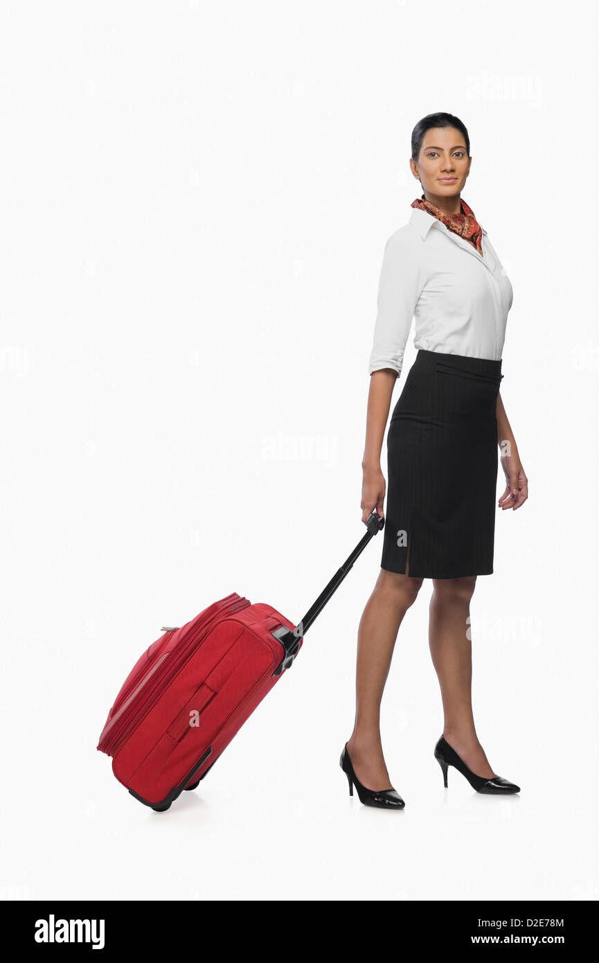 Air hostess carrying her luggage Stock Photo