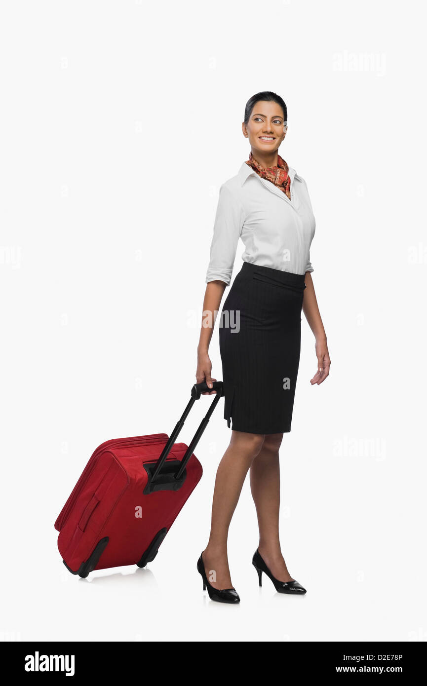 Air hostess carrying her luggage Stock Photo