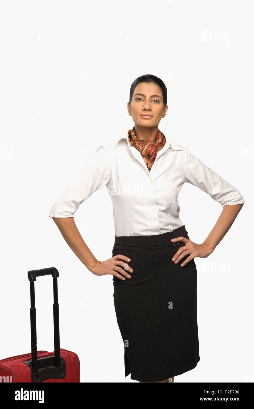 Portrait of an air hostess with her luggage Stock Photo