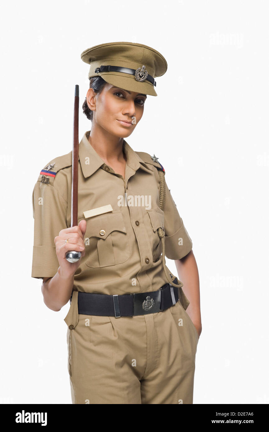 Portrait of a female police officer holding a stick Stock Photo