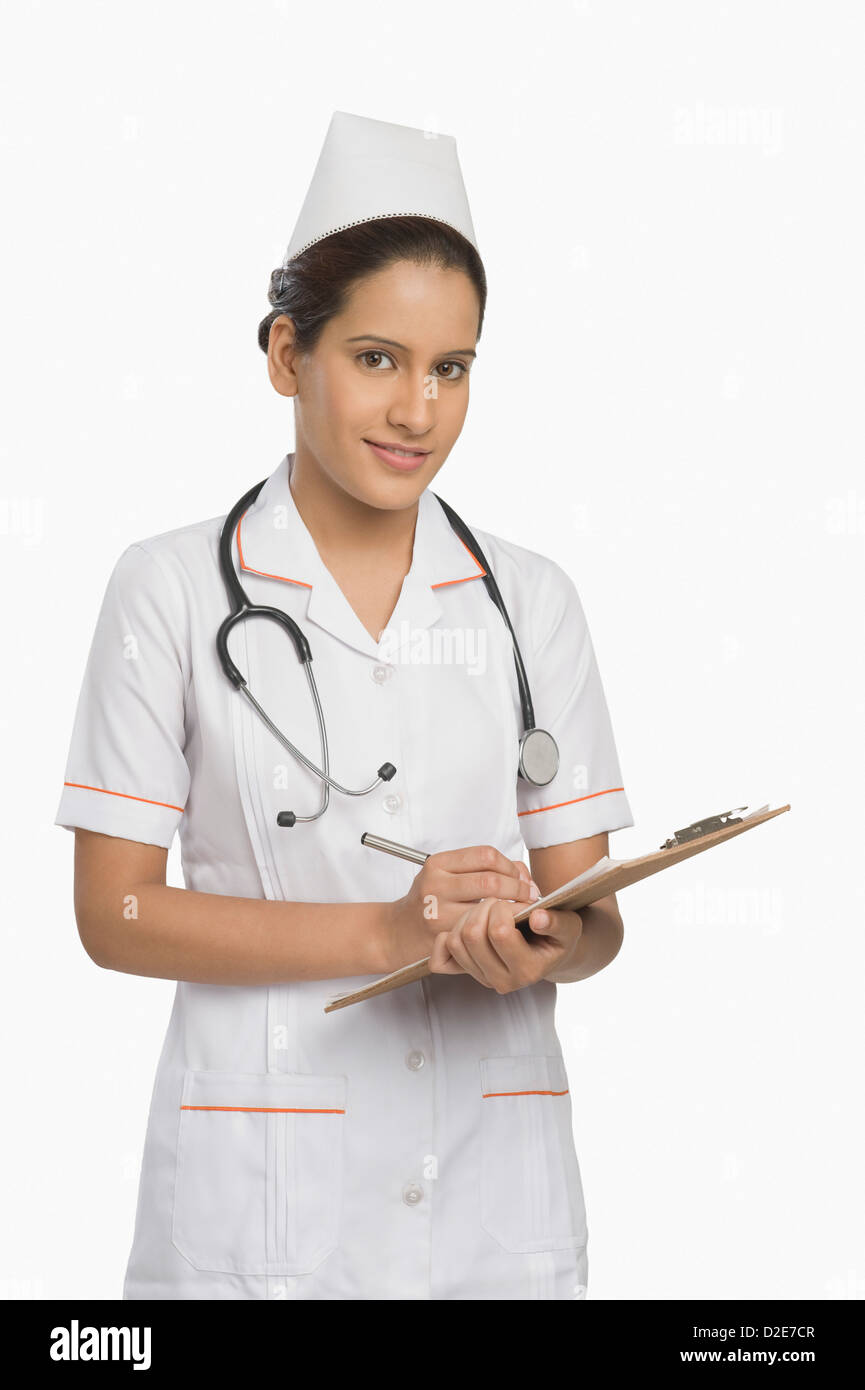 Female nurse holding a clipboard and smiling Stock Photo - Alamy