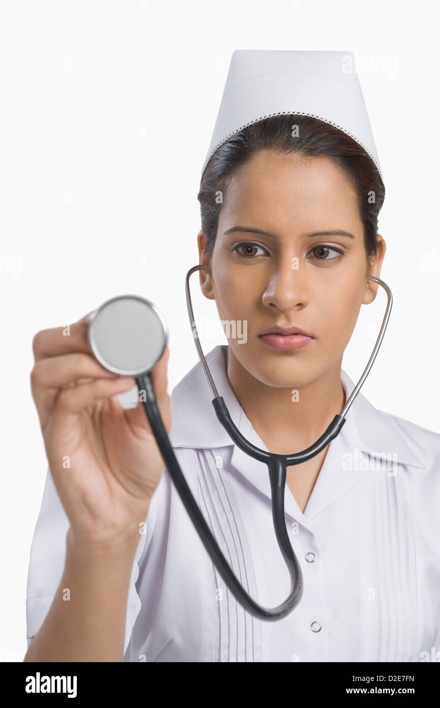 Female nurse holding a stethoscope Stock Photo - Alamy