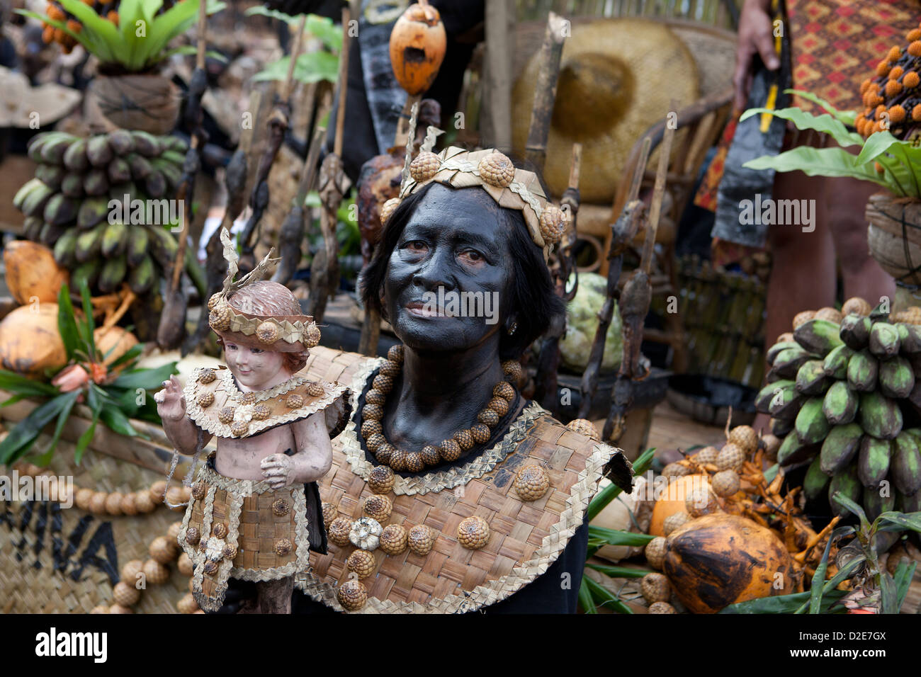 Street dancer holding Santo Nino figurine, Ati-Atihan festival 2013,Kalibo,Aklan,Philippines Stock Photo
