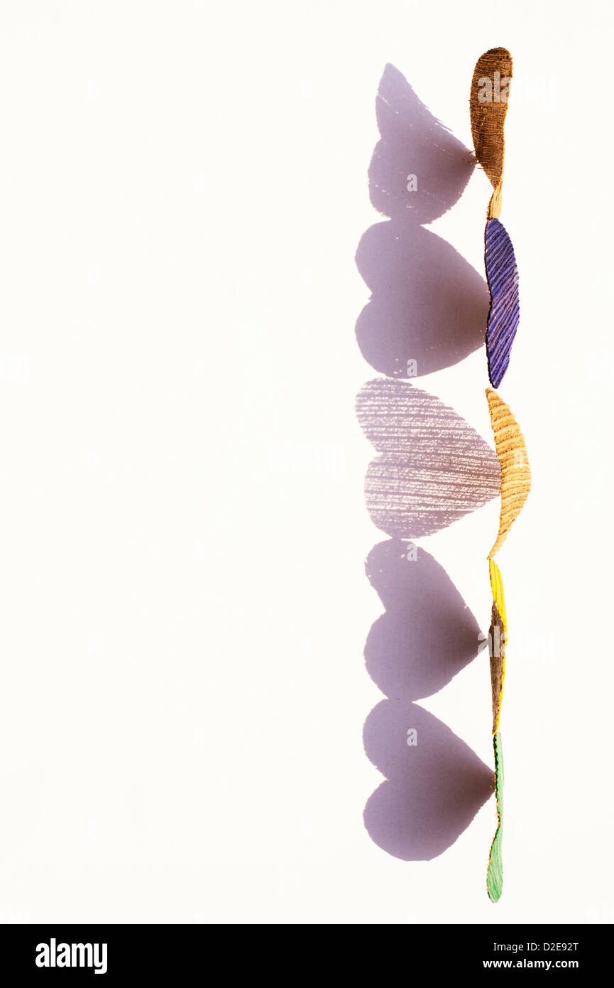 Line of coconut husk bark heart shapes with shadows on white Stock ...