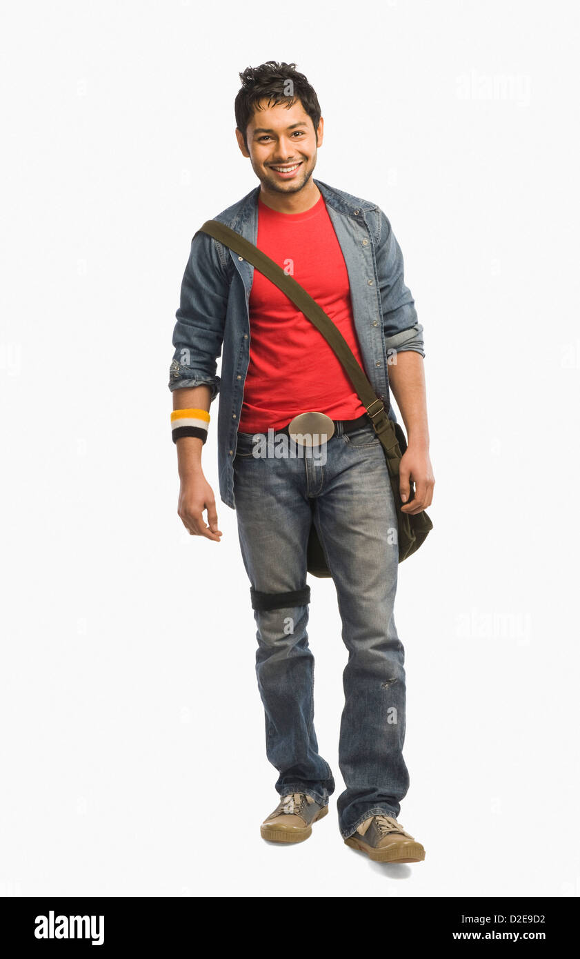 University student with a shoulder bag and smiling Stock Photo - Alamy