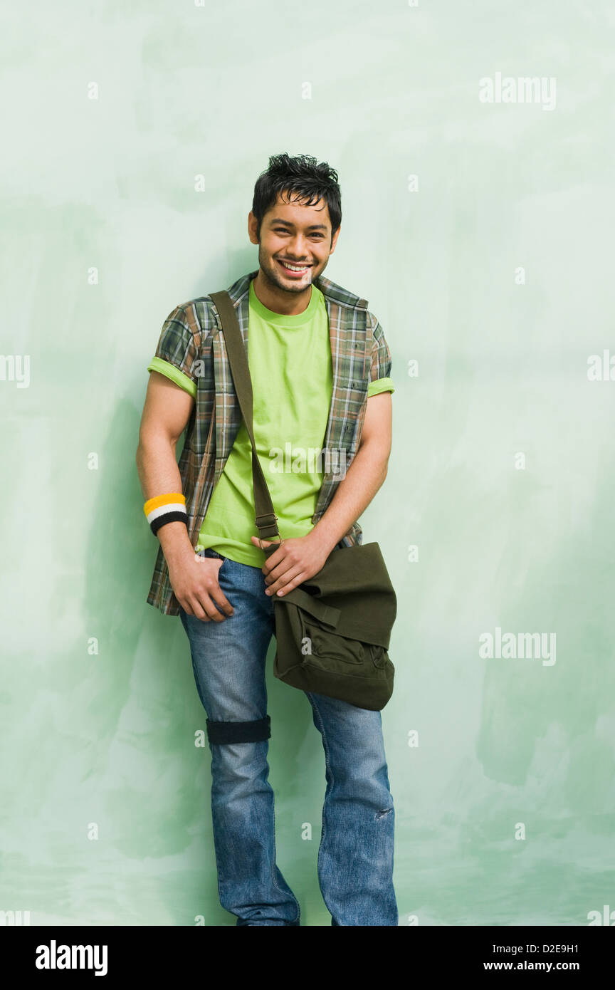 University student with a shoulder bag and smiling Stock Photo - Alamy