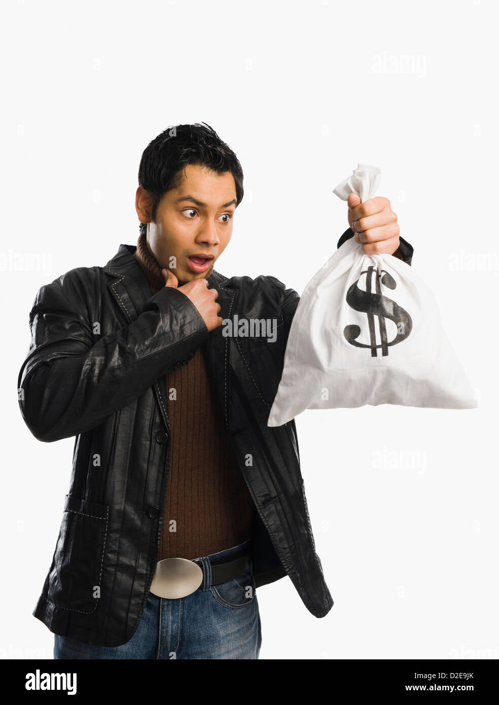 Man holding a money bag and looking surprised Stock Photo