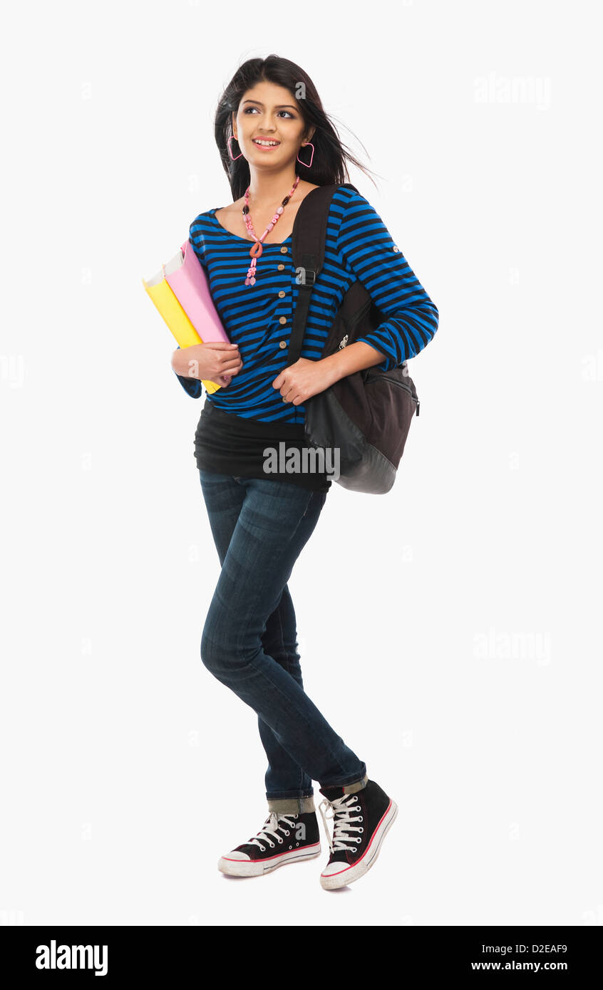 Female university student holding books and smiling Stock Photo - Alamy