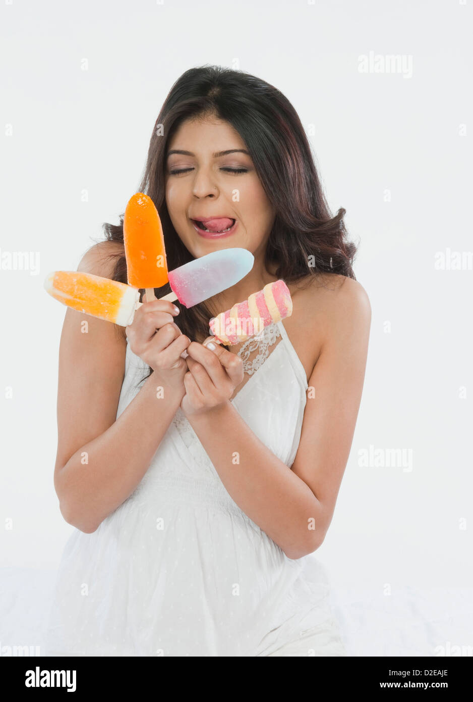 Woman holding ice creams and licking lips Stock Photo Alamy