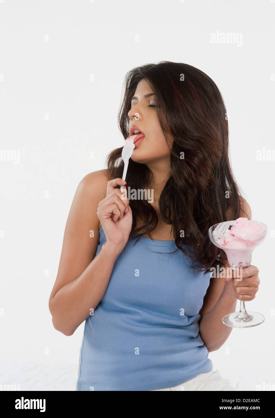 Closeup of a woman licking a spoon of ice cream Stock Photo Alamy