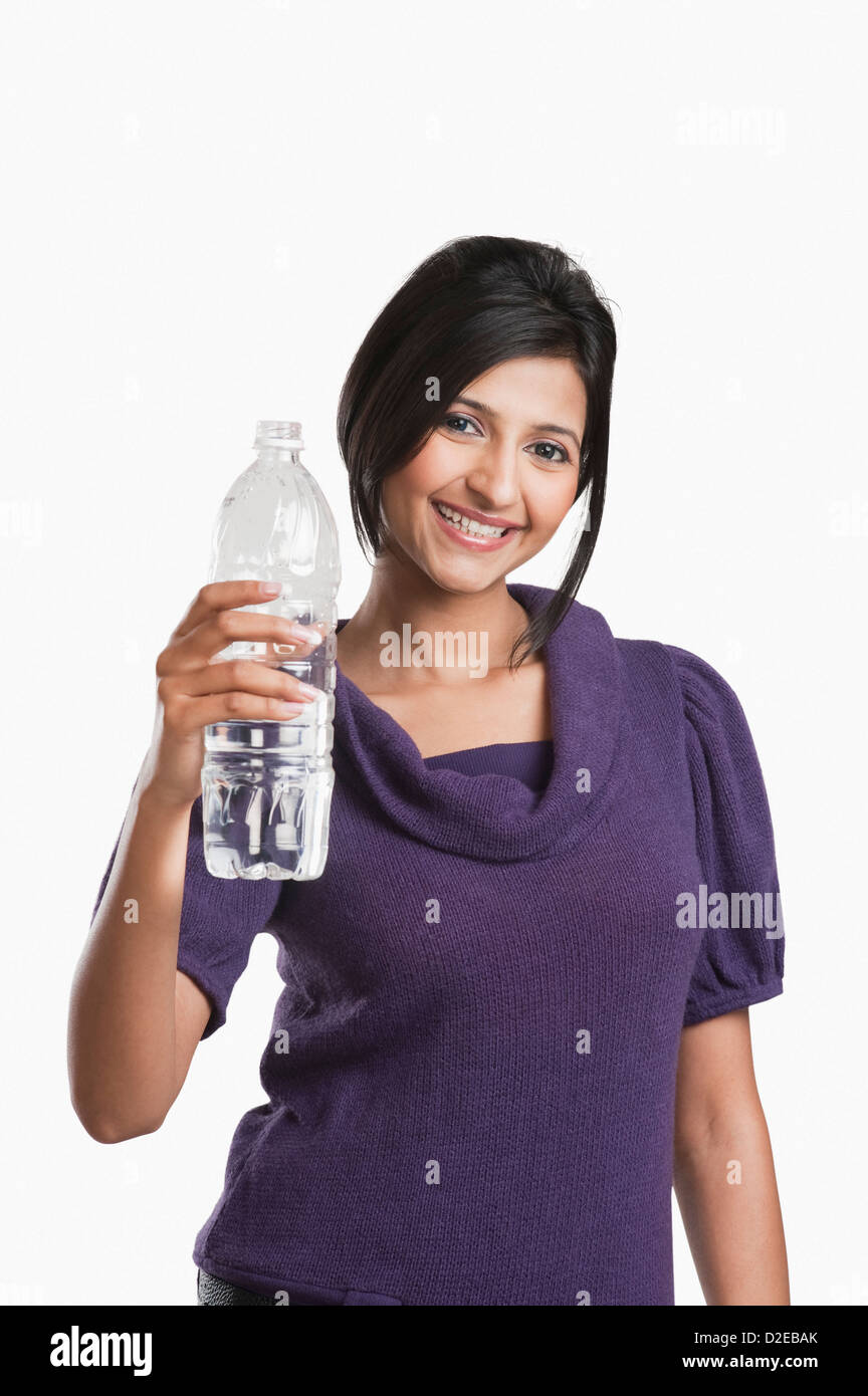 Woman holding a water bottle and smiling Stock Photo - Alamy