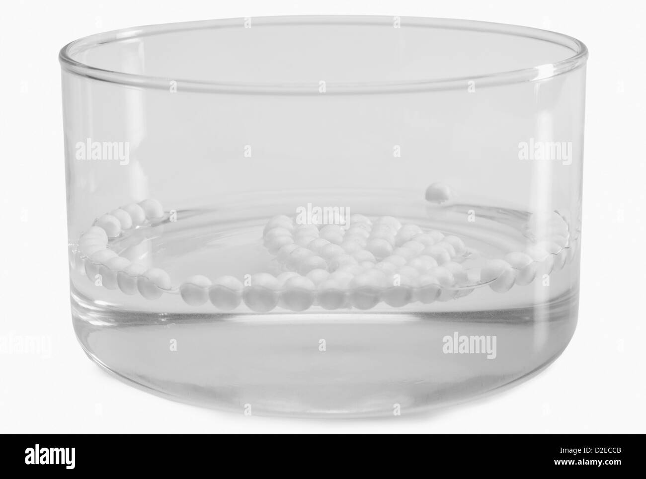 Close-up of styrofoam balls floating on water in a bowl Stock Photo