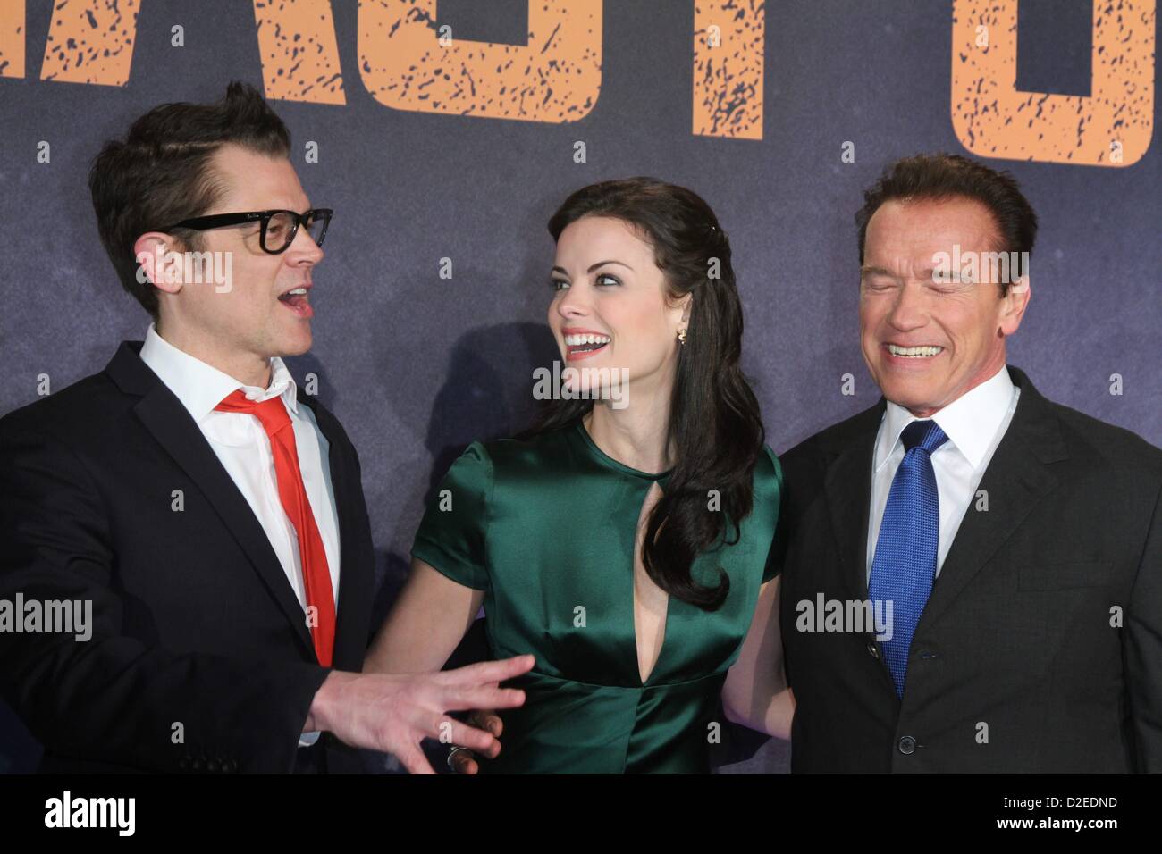 Actors Johnny Knoxville, Arnold Schwarzenegger, and Jamie Alexander attend to the Premiere of the movie 'The Last Stand' in Cologne, Germany, on January 21, 2013. Stock Photo