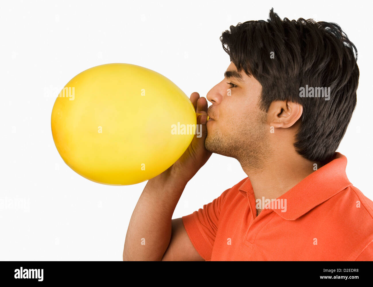 Man blowing up a balloon Stock Photo Alamy
