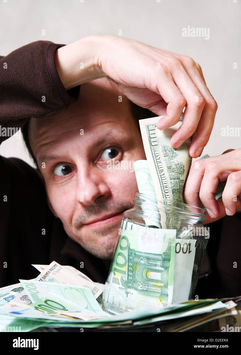 The adult the man with money in bank Stock Photo - Alamy